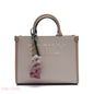 EMBOSSED LOGO TOTE BAG WITH TASSEL CHARM - SMALL
